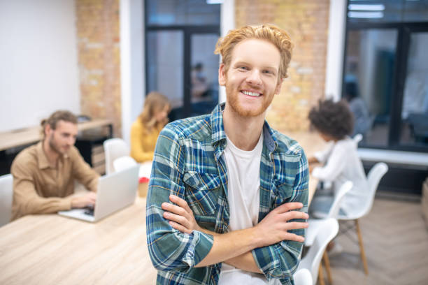 istock Smiling ginger guy in a checkered shirt looking happy 1304964584
