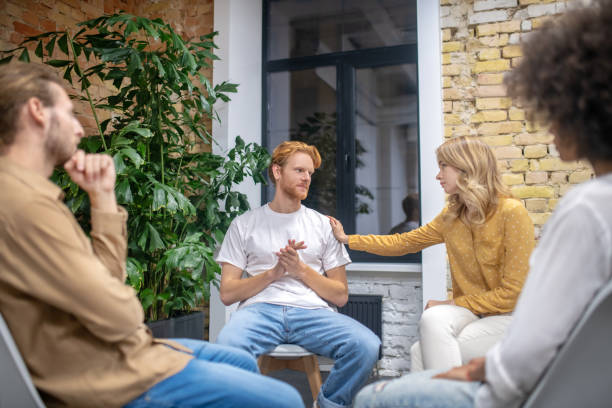 istock Group of people sitting in a circle and talking 1304964619