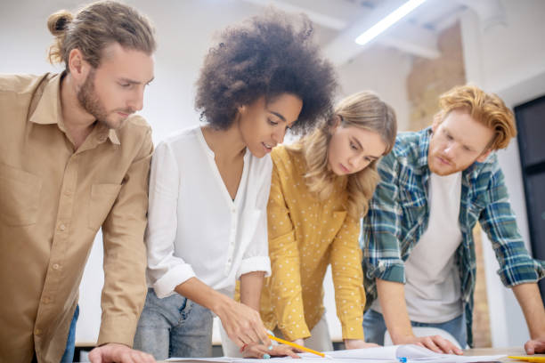 istock Group of young professionals working on the project together and looking concentrated 1304964703