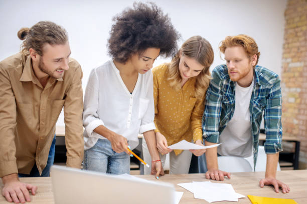 istock Group of young professionals working on the project together and looking concentrated 1304964705