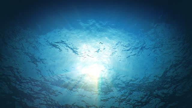 Beautiful Underwater Sun Light Beams Shining Through the Deep Blue Clear Water Seamless. Loop 3d Animation of Waving Water Surface from the Deep.