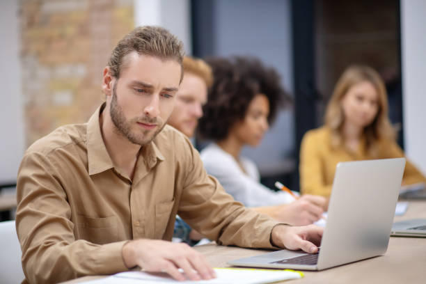 istock Group of students sitting in the classroom and looking happy 1304964779