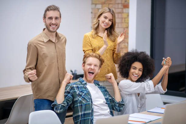 istock Group of students sitting in the classroom and looking happy 1304964786