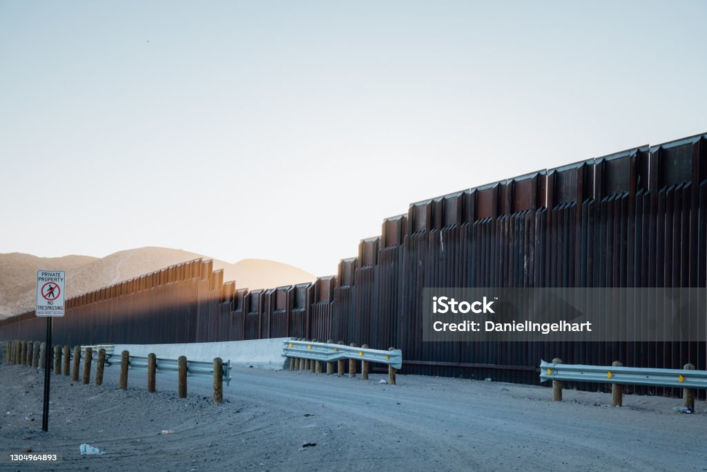 Border Wall At the El Paso Border Crossing Into Juarez US, Mexican border wall that separates El Paso, Texas and Juarez International Border Barrier Stock Photo