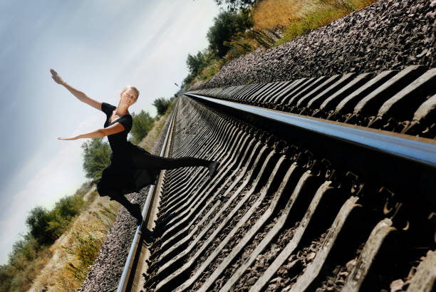 istock Fearless ballet dancer on the railroad track striking a pose 1304966362