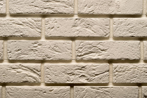 istock View of a white brick wall, white background 1304967482