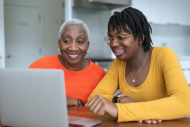 istock Young granddaughter using technology with her grandma 1304967502