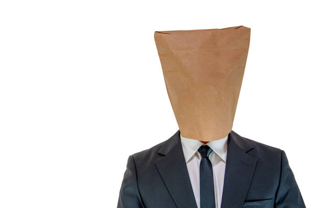 Man wearing a paper bag on his head out of embarrassment Man wearing a paper bag on his head out of embarrassment on isolated white background anonymous businessman with paper bag on his head stock pictures, royalty-free photos & images