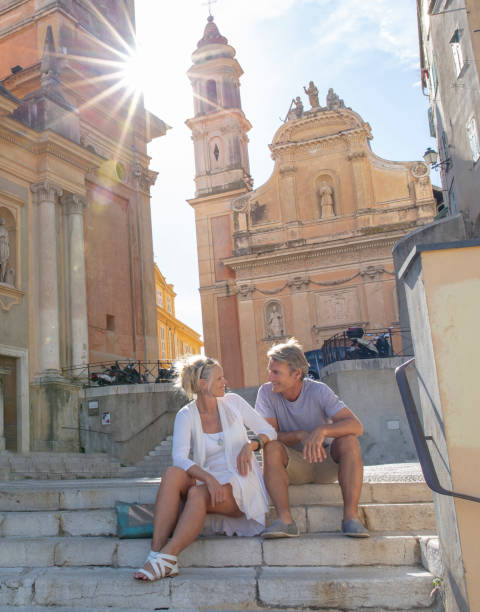 Couple sit on old steps leading to old town