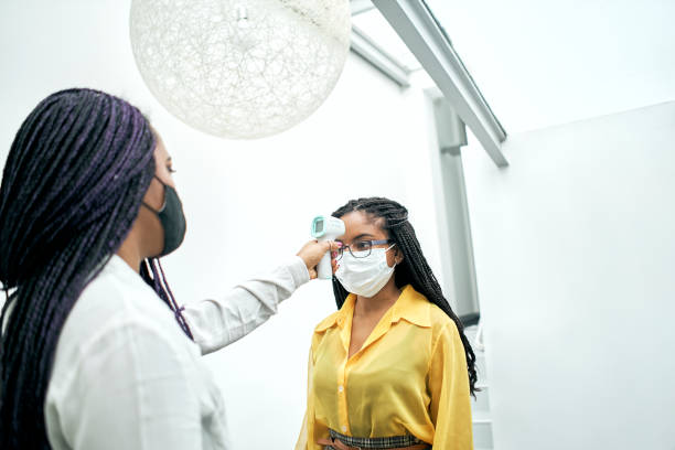 istock Body temperature check, prevent virus Concepts in preventing contagious diseases. Social distancing concept. Operator Check Fever by Digital Thermometer Visitor 1304971157