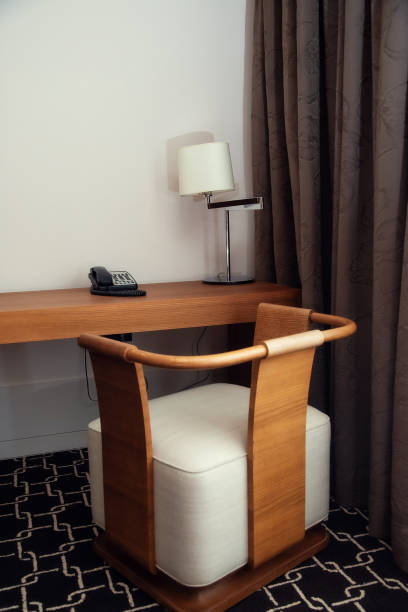 istock Typical hotel room. Writing desk with table lamp and armchair. 1304972293