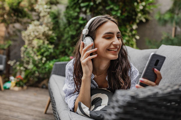 istock Young woman is using mobile phone at home 1304973259