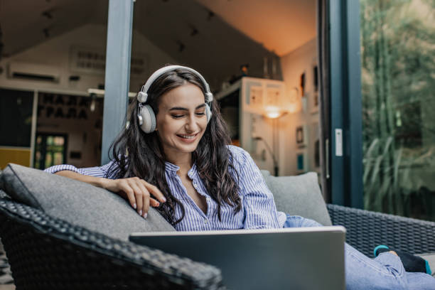istock Young woman is using laptop at home on the balcony 1304973297