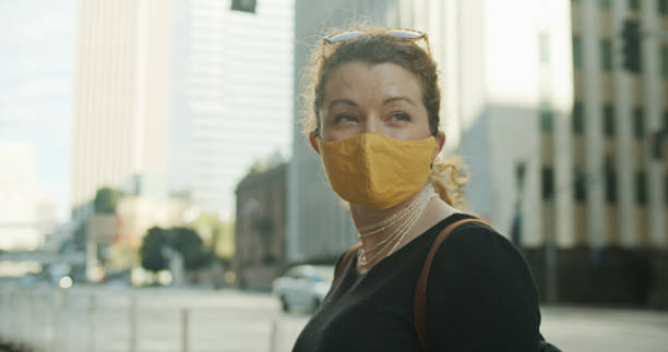 istock Lone Masked Woman in Downtown 1304974136