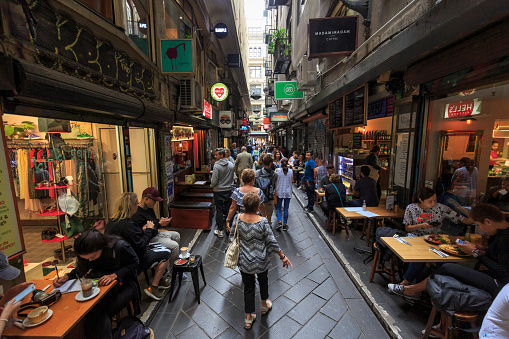Melbourne, Australia,- March 12, 2018: Pedestrians walking down Leicester Street, Melbourne, Australia. This is a busy area with many cafes and bars.