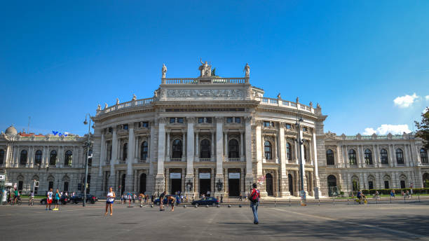 Burgtheater in Vienna Vienna, Austria - 10.09.2016: The Burgtheater (Hofburg Theater) is the Austrian National Theatre. It is one of the most important German language theatres in the world and was created in 1741 as part of the Hofburg complex. Wide angle view. Two theater workers are selling tickets outside. burgtheater vienna stock pictures, royalty-free photos & images