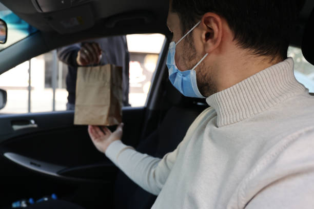 istock Young man picking up his restaurant food from her car 1304977317