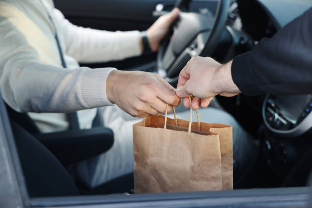 istock Young man picking up his restaurant food from her car 1304977372