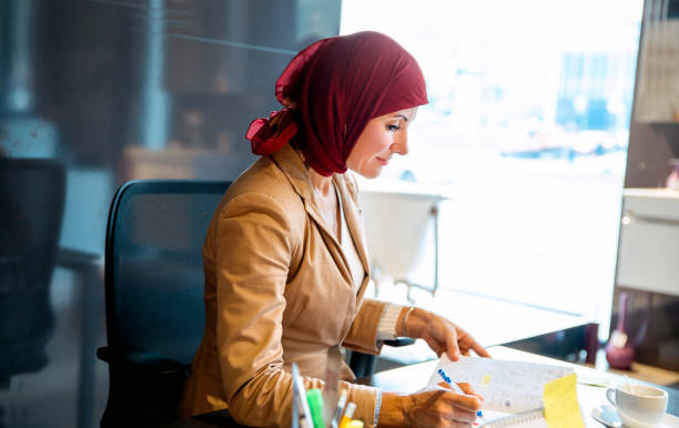 istock Elegant Arab Business Woman at work, writing notes 1304978879