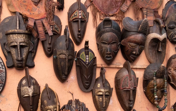 african masks at a market in marrakech, morroco