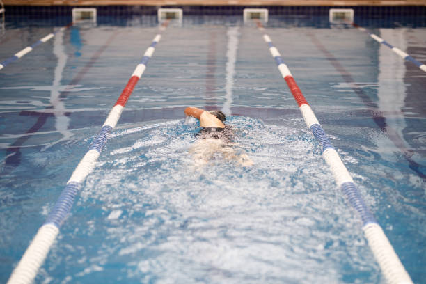 istock One armed female swimmer swimming freestyle 1304988824