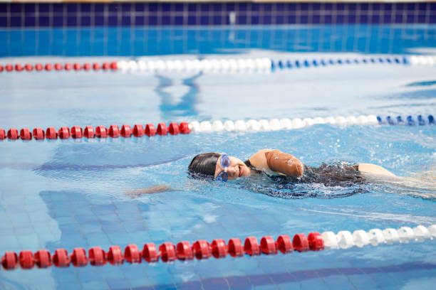 istock One armed female swimmer swimming freestyle 1304988845