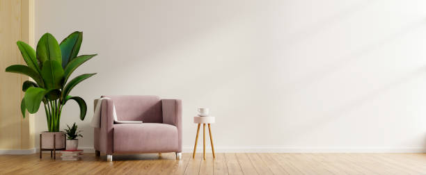 istock Modern minimalist interior with an armchair on empty white wall background. 1304993230