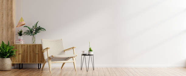 istock Modern minimalist interior with an armchair on empty white wall background. 1304993232
