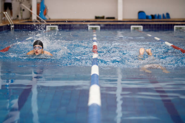 istock Two young female swimmers competing swimming breaststroke 1305000257
