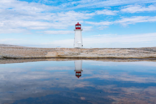 Peggy's Point Lighthouse Reflection Reflection of Peggy's Point Lighthouse near Peggy's Cove, Nova Scotia, Canada lighthouse lighting equipment reflection rock stock pictures, royalty-free photos & images