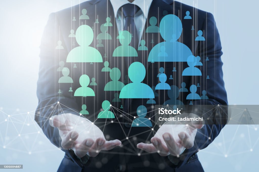 Digital marketing and customers on internet. Business person holding network structure and customer icons. Human Resources Stock Photo