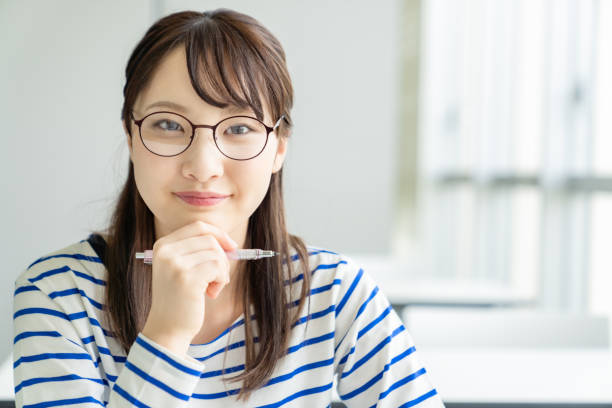 istock Young asian female student in classroom. 1305005080