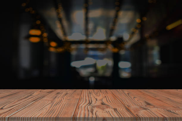 istock Empty wood table top and blur of night Restaurant background 1305009070