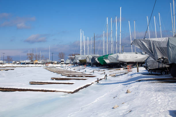 Sailboats line the perimeter of the Thornbury Yacht Club during the winter months when the harbor is frozen stock photo