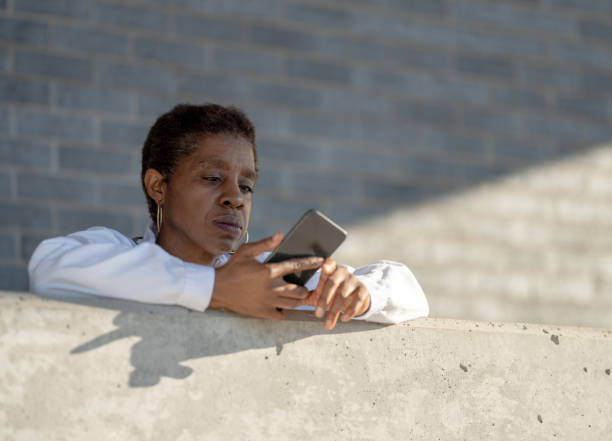 istock Doctor Checking Her Phone Stock Photo 1305011752