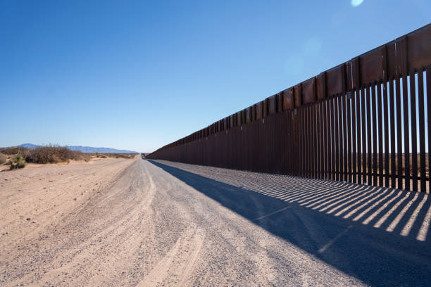 Border Wall At the El Paso US, Mexican border wall that separates El Paso, Texas and Juarez international border barrier stock pictures, royalty-free photos & images