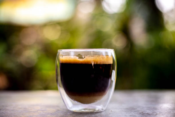 istock Black coffee in glass and blurred background 1305013280