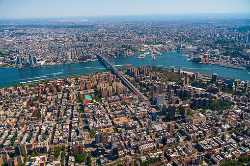 Aerial view of New York City from a helicopter on a sunny summer day.