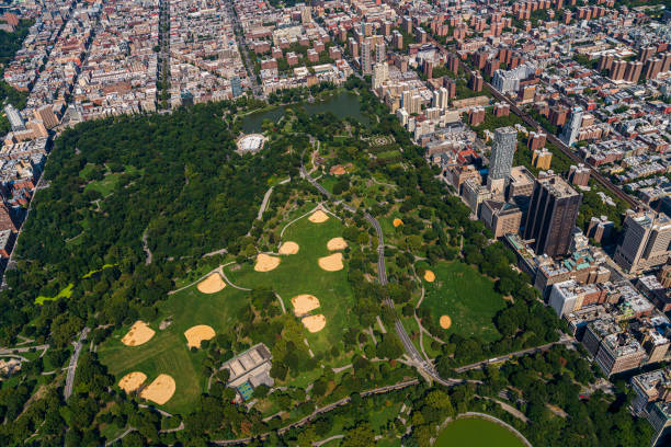 Aerial view of Central Park, Manhattan, from a helicopter on a sunny summer day. Aerial view of New York City from a helicopter on a sunny summer day. harlem park stock pictures, royalty-free photos & images