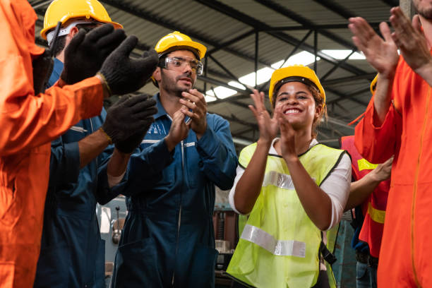 Skillful worker celebrate success in the factory . stock photo