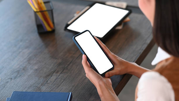 istock Young woman resting in office and using smart phone. 1305024901