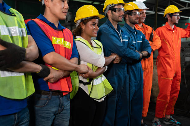istock Skillful worker stand together showing teamwork in the factory . 1305025897
