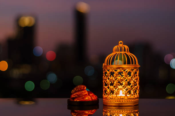 istock Ramadan Kareem lantern and dates fruit with city light background. 1305026518