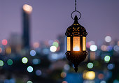 Ramadan Kareem lantern with city light background.