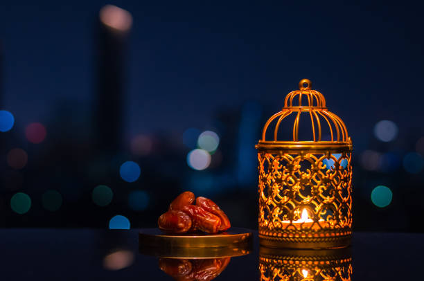 istock Ramadan Kareem lantern and dates fruit with city light background. 1305026537