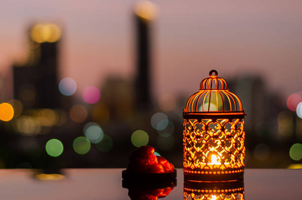 istock Ramadan Kareem lantern and dates fruit with city light background. 1305026611