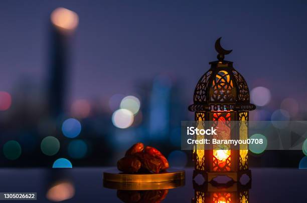 Ramadan Kareem Lantern And Dates Fruit With City Light Background Stock Photo - Download Image Now