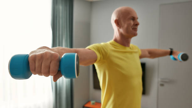 istock Trainer in sportswear working out at home 1305027780