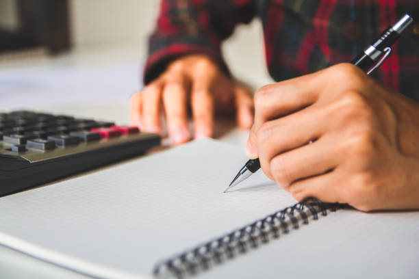 istock writing report bonus(Or other compensation) to employees to increase productivity, work from home, quarantine. Selective Focus 1305029285