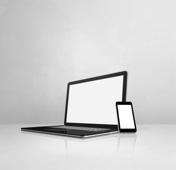 istock Laptop and mobile phone on white concrete office desk 1305029625